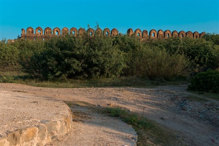 Rohtas Fort wall view surrounded by green bushes