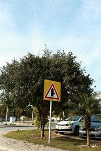 intersection with minor side-road on the right sign mounted on silver pole