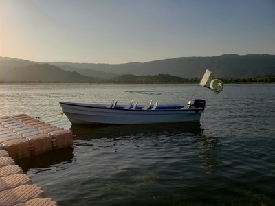 Boad in Lake with Pakistani Flag