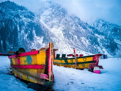 Boats on snow lake in North Mountains