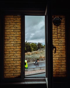 Bike rider on a road through the window