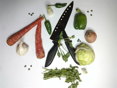 Black knives with vegetables