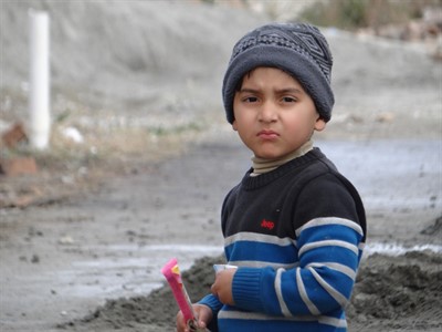 Kid in blue sweater and wool hat